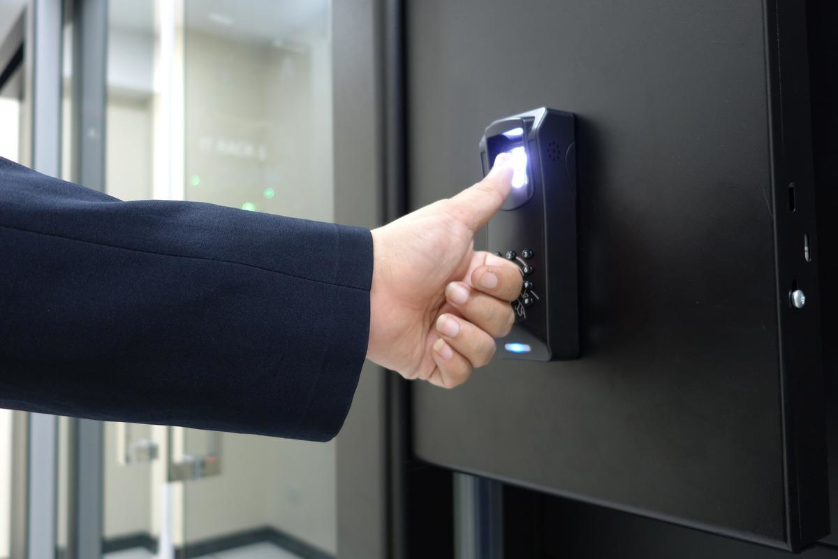 Man using fingerprint to enter building