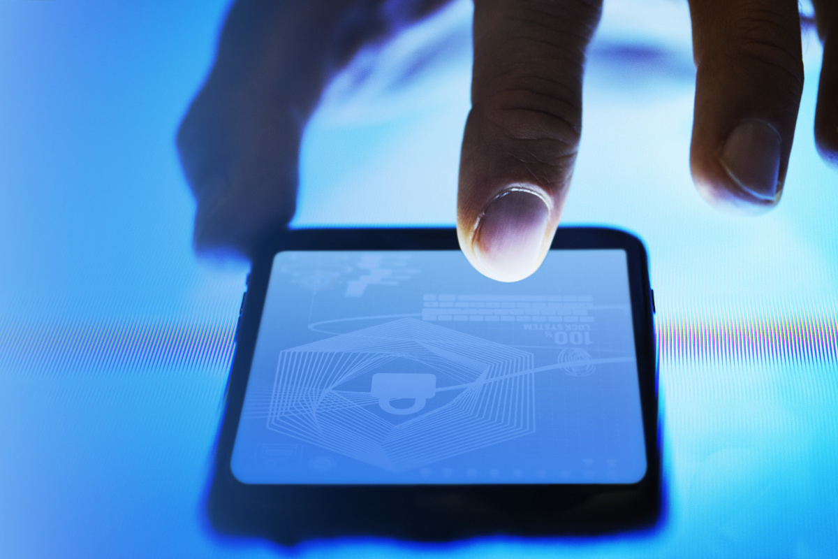 Man using tablet with digital padlock on it